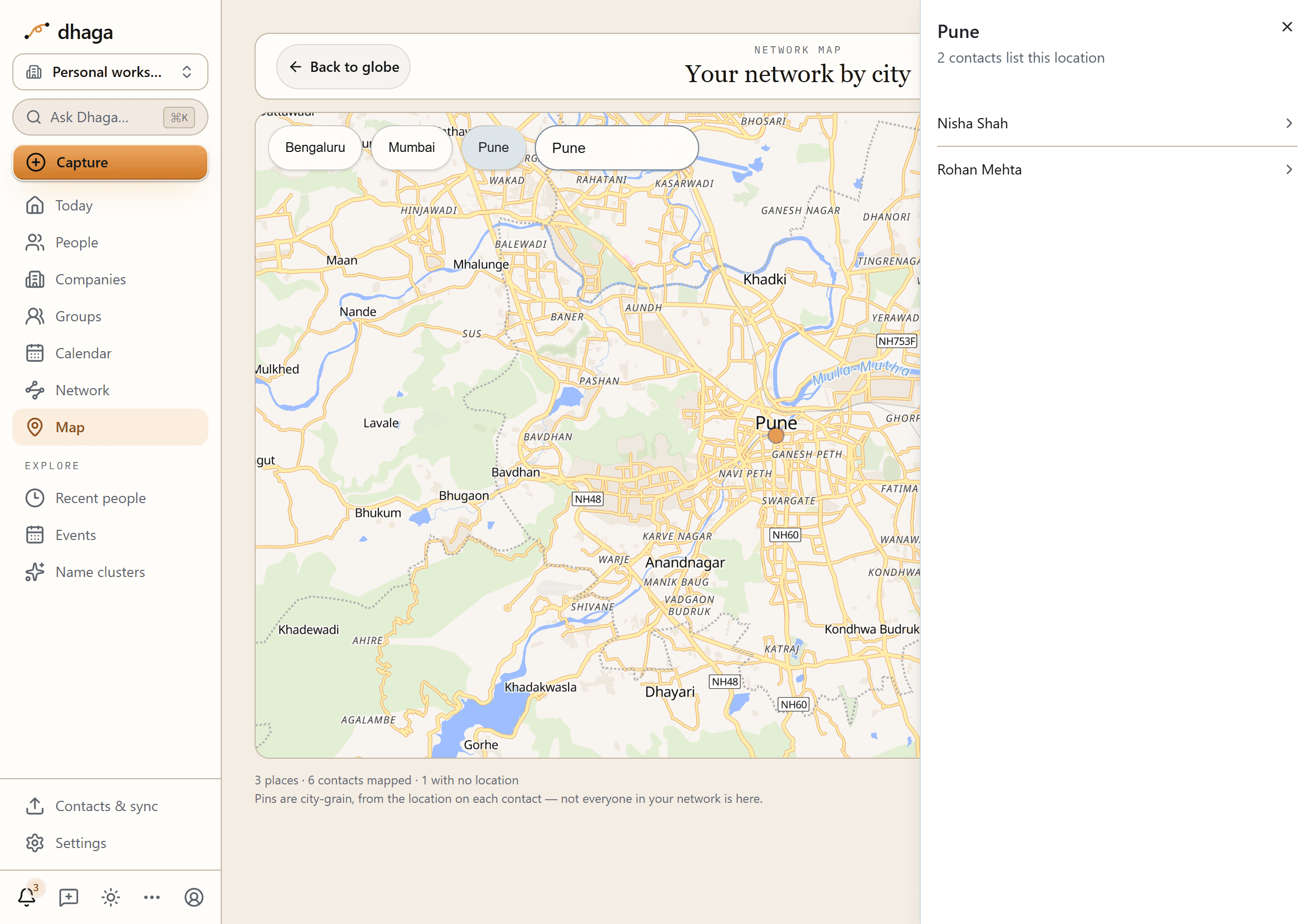 The contact map framed on one city with its place panel open at the right: the city name, "2 contacts list this location" and the two people underneath, over a map that is still sharp, unblurred and draggable