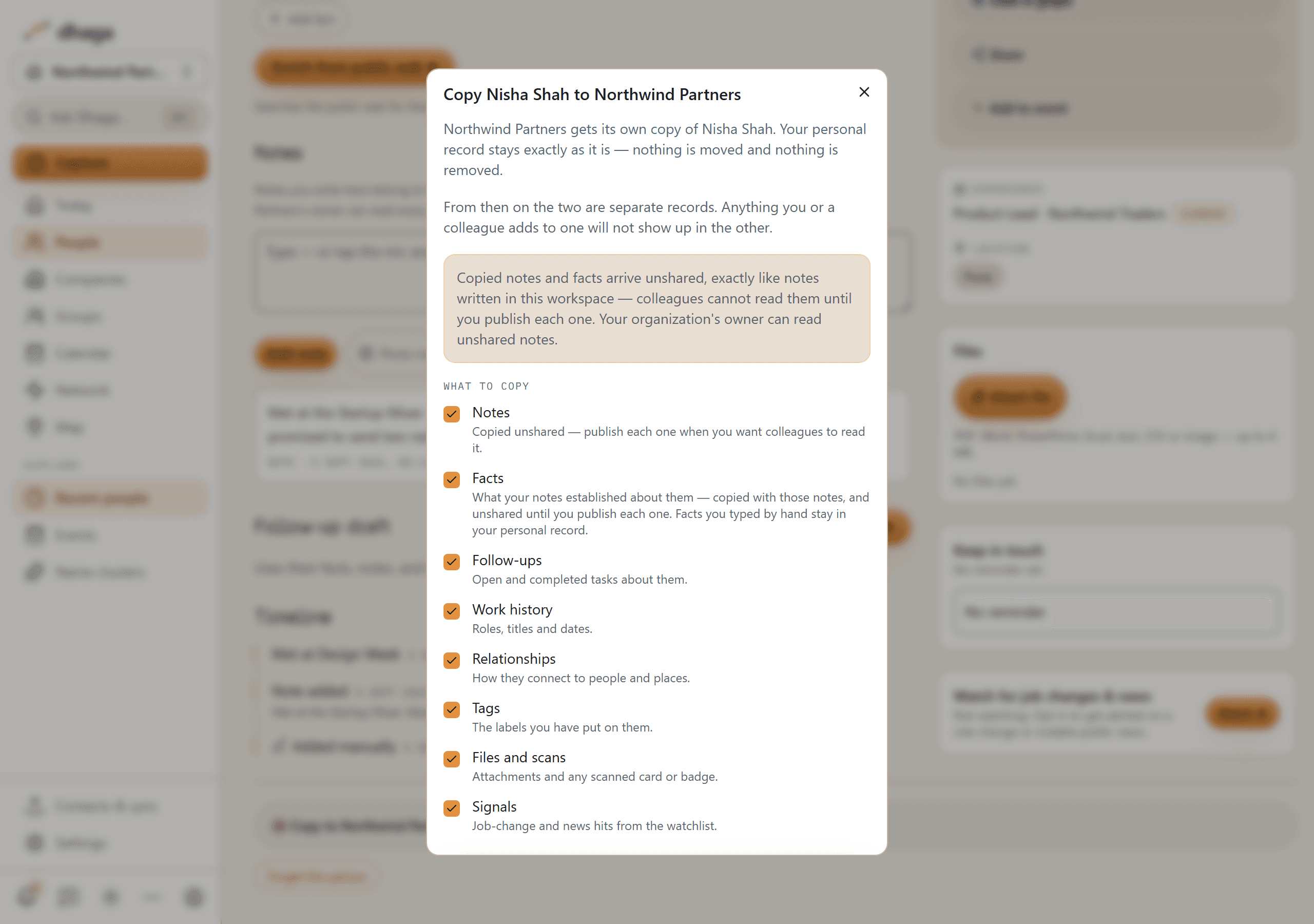 The Copy to organization dialog over a contact page: a note that the organization gets its own copy and the personal record stays as it is, a panel saying copied notes and facts arrive unshared, and a What to copy list — notes, facts, follow-ups, work history, relationships, tags, files and scans, signals — every box ticked